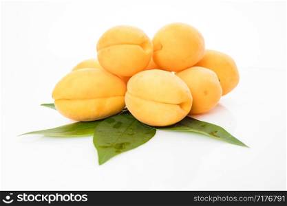 Apricot fruit with leaf isolated on white background