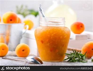 apricot jam in glass jar and on a table