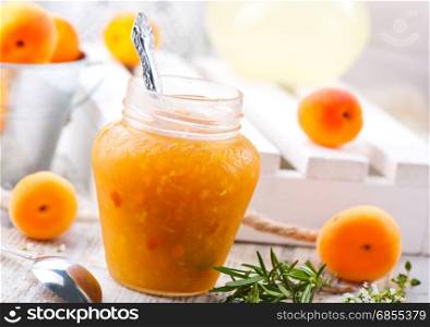 apricot jam in glass jar and on a table