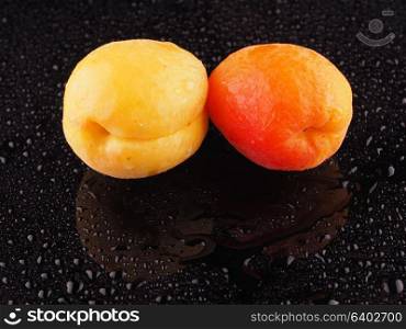 Apricot on a dark background with droplets