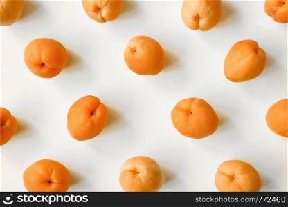 Apricot on white background. Apricot pattern. Top view, flat lay. Summer fruits. Apricot on white background. Apricot pattern. Top view, flat lay. Summer fruit