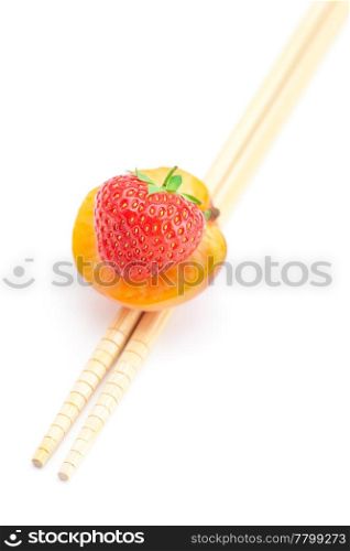 apricot,strawberry and chopsticks isolated on white
