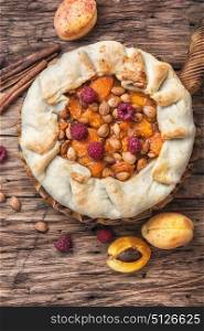 Apricot tart pie. Apricot cake on a rustic old table with fruits