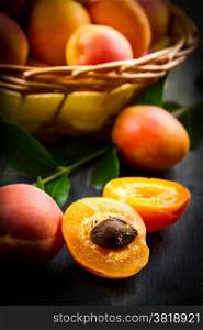 Apricots with leaves on the old wooden table