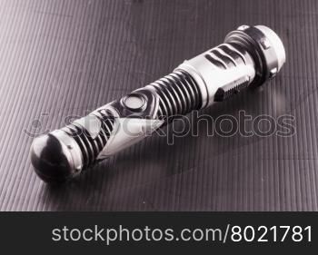 APRIL 6, 2016: toy lightsaber from Star Wars over black background. Star Wars is the most famous science fiction movie franchise of the world.