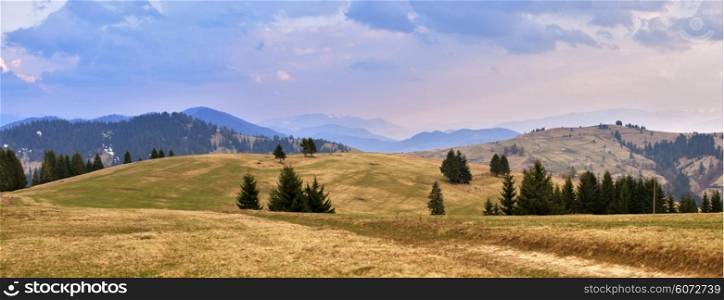 April evening in Carpathian mountains. Spring hills and fields.