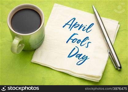 April Fools&rsquo; Day -handwriting on a napkin with a cup of coffee