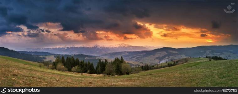 April storm and sunset in Carpathian mountains. Spring evening