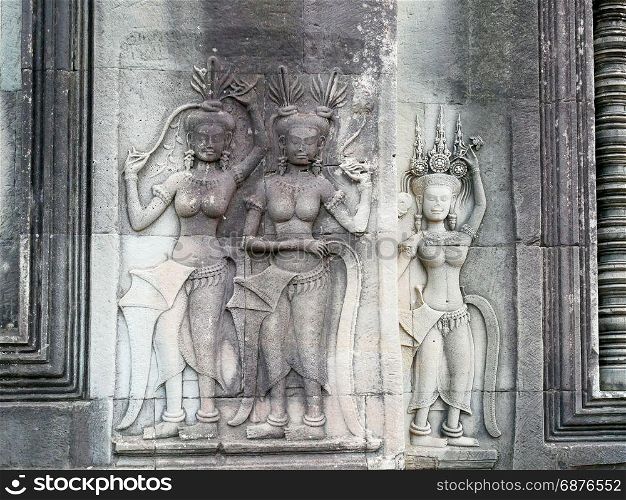 Apsara dancers stone carving all around on the wall at Angkor Wat, Siem Reap, Cambodia.
