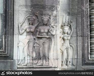 Apsara dancers stone carving all around on the wall at Angkor Wat, Siem Reap, Cambodia.