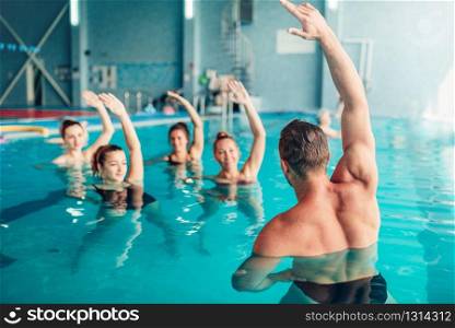 Aqua aerobics in water sport center, indoor swimming pool, recreational leisure. Aqua aerobics in water sport center