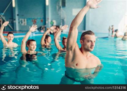 Aqua aerobics in water sport center, indoor swimming pool, recreational leisure. Aqua aerobics in water sport center