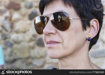 Aqueduct of Segovia reflected in the glasses of a woman’s sunglasses. Travel concept. Spain, Castile and Leon, Segovia. 