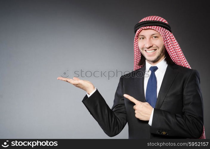 Arab businessman handing hands againt grey background