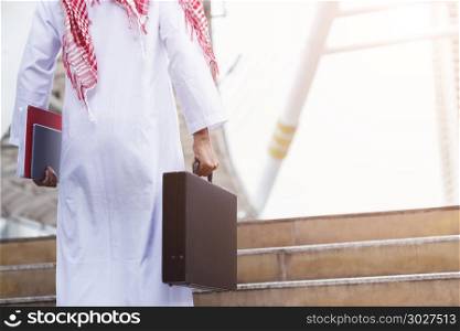 Arab businessman holding file and business bag with free copy sp. Arab businessman holding file and business bag with free copy space. Picture for add text message. Backdrop for design art work.