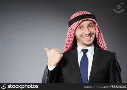 Arab businessman in delight against grey background
