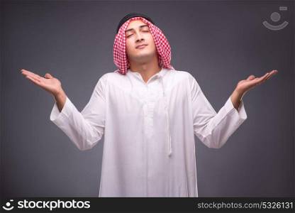Arab businessman on gray background