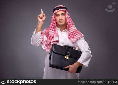 Arab businessman on gray background