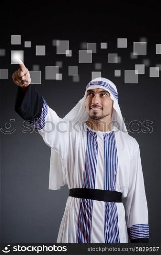 Arab businessman pressing virtual buttons