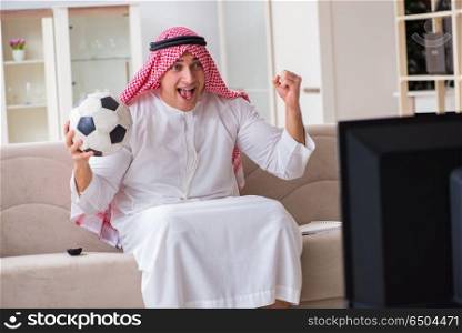 Arab businessman watching tv at home