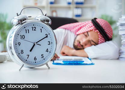 Arab businessman working in the office doing paperwork with a pi. Arab businessman working in the office doing paperwork with a pile of papers