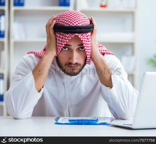 Arab businessman working in the office doing paperwork with a pile of papers. Arab businessman working in the office doing paperwork with a pi