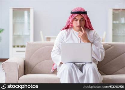 Arab businessman working sitting at couch