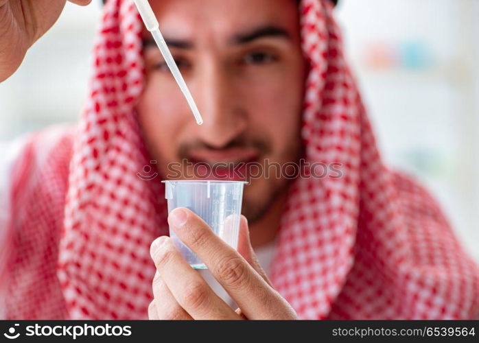 Arab chemist checking the quality of drinking water