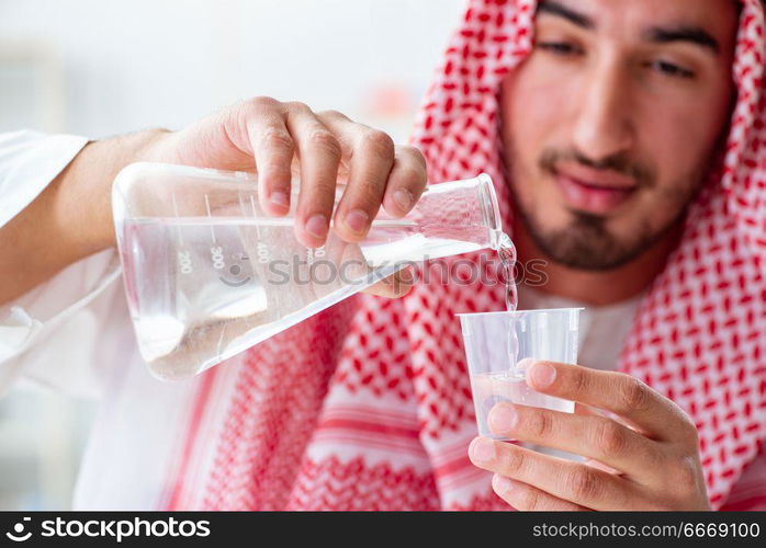 Arab chemist checking the quality of drinking water