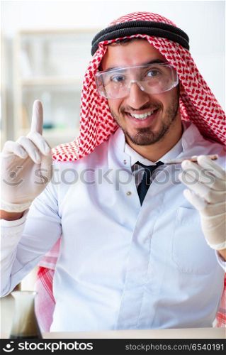 Arab chemist scientist testing quality of oil petrol