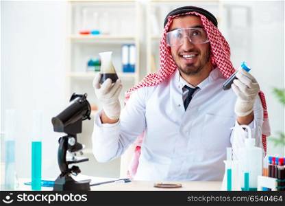 Arab chemist scientist testing quality of oil petrol