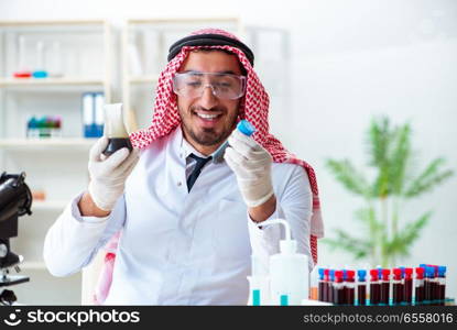 Arab chemist scientist testing quality of oil petrol