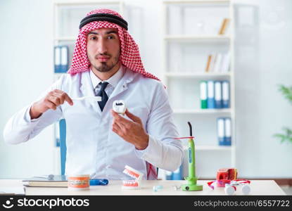 Arab dentist working on new teeth implant