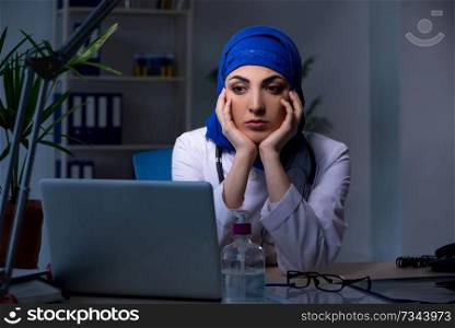 Arab female doctor working in the clinic at night 