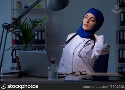 Arab female doctor working in the clinic at night 