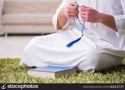 Arab man praying at home