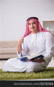 Arab man praying at home