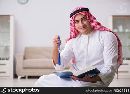 Arab man praying at home