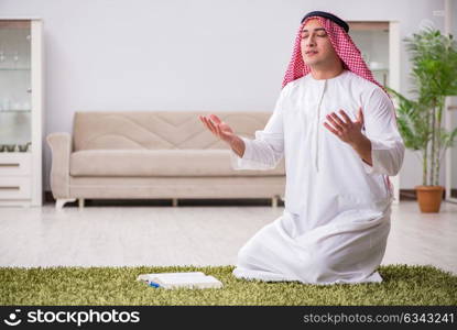 Arab man praying at home