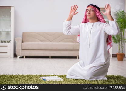 Arab man praying at home