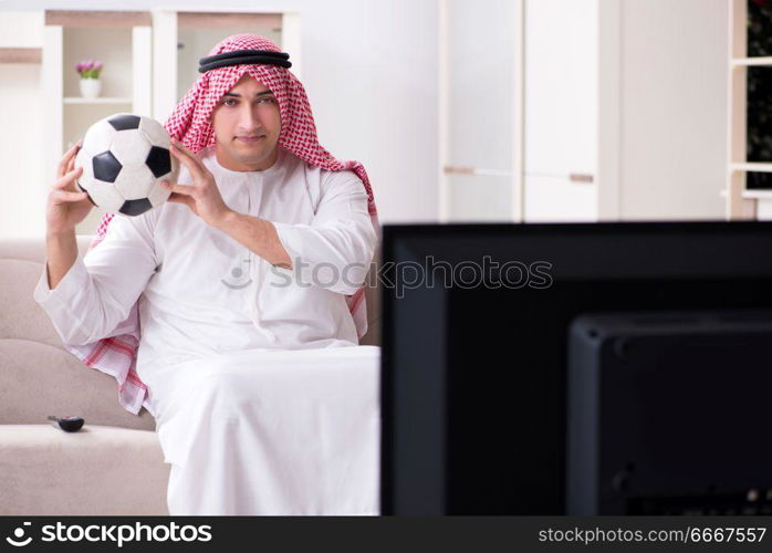 Arab man watching tv at home