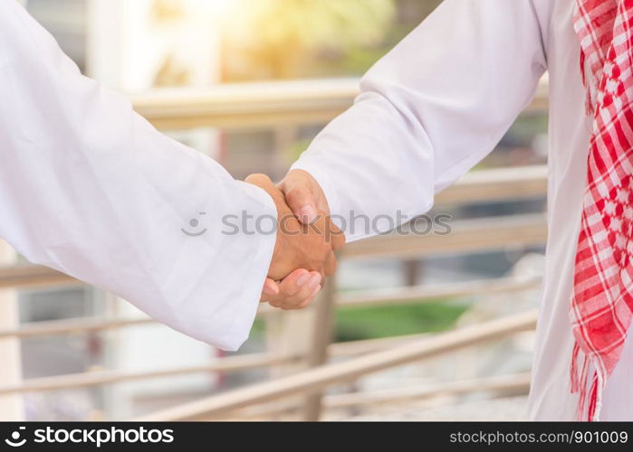 Arab middle eastern Business man handshake at outside office, Success and Happiness Team Concept.