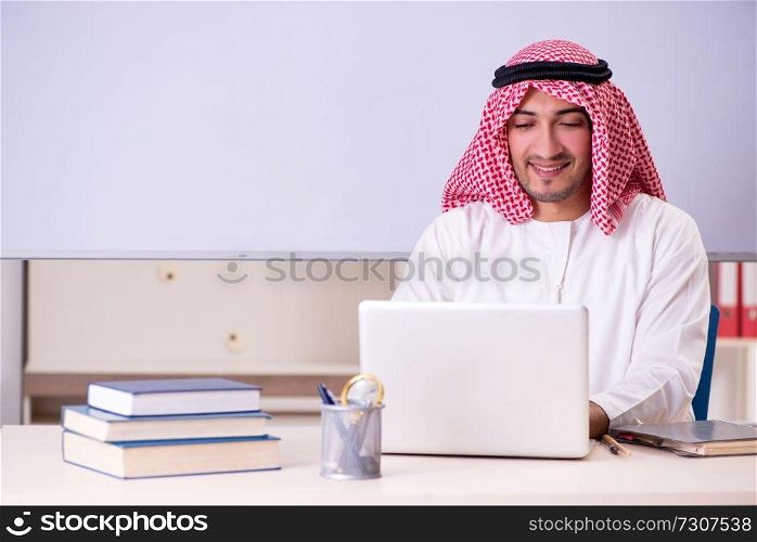 Arab teacher in front of whiteboard 