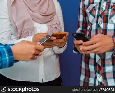 Arab teenagers group using smartphones for social media networking and sharing information for online education. Selective focus. High quality photo. Arab teenagers group using smart phones for social media networking and sharing of informations for online education. Selective focus 