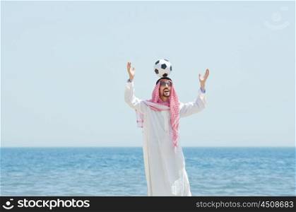 Arab with footbal at seaside