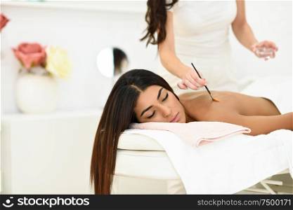 Arab woman in wellness beauty spa having aroma therapy massage with essential oil, looking relaxed Beauty and Aesthetic concepts.. Arab woman in wellness beauty spa having aroma therapy massage