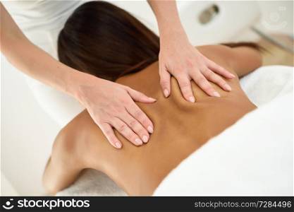 Arab woman receiving back massage in spa wellness center. Beauty and Aesthetic concepts.