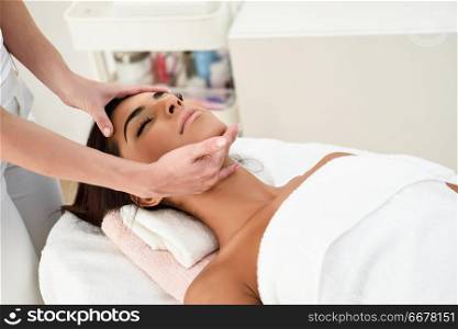 Arab woman receiving head massage in spa wellness center. Beauty and Aesthetic concepts.. Woman receiving head massage in spa wellness center.