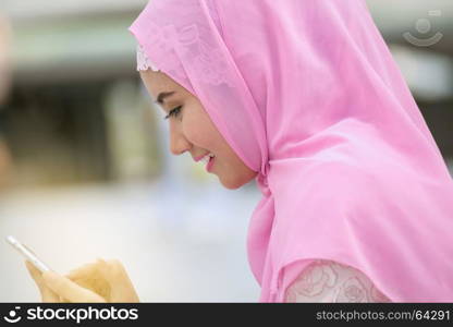 Arabian business woman smiling happy to use cell phone and modern business city background