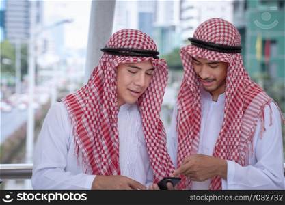 Arabian businessman using cell phone with colleauge for presenting business concept background